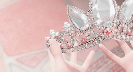 a picture of rapunzel, out of frame, holding her crown.
